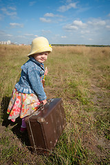 Image showing lonely girl with suitcase. Back view