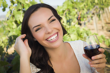 Image showing Young Adult Woman Enjoying A Glass of Wine in Vineyard