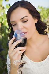 Image showing Young Adult Woman Enjoying A Glass of Wine in Vineyard