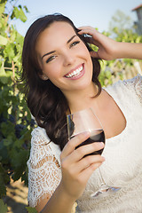 Image showing Young Adult Woman Enjoying A Glass of Wine in Vineyard