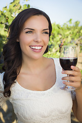Image showing Young Adult Woman Enjoying A Glass of Wine in Vineyard