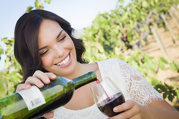 Image showing Young Adult Woman Enjoying A Glass of Wine in Vineyard