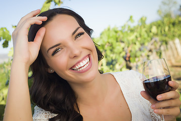 Image showing Young Adult Woman Enjoying A Glass of Wine in Vineyard