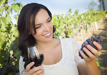 Image showing Young Adult Woman Enjoying A Glass of Wine in Vineyard