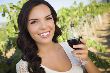 Image showing Young Adult Woman Enjoying A Glass of Wine in Vineyard