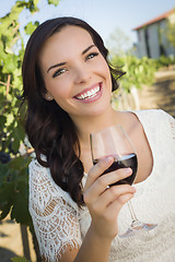 Image showing Young Adult Woman Enjoying A Glass of Wine in Vineyard