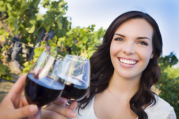 Image showing Young Woman Enjoying Glass of Wine in Vineyard With Friends