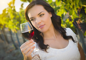 Image showing Young Adult Woman Enjoying A Glass of Wine in Vineyard