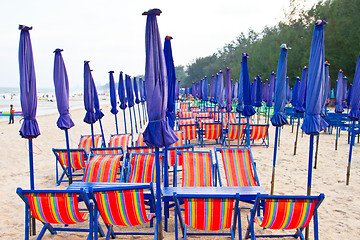 Image showing Beach chair and colorful umbrella on the beach. Thailand