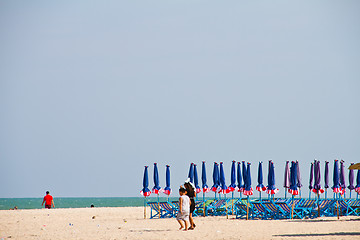 Image showing Beach chair and colorful umbrella on the beach. Thailand