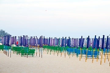 Image showing Beach chair and colorful umbrella on the beach. Thailand