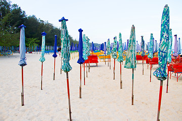 Image showing Beach chair and colorful umbrella on the beach. Thailand
