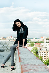 Image showing Young woman on roof