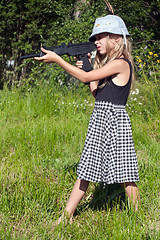 Image showing little girl firing a big gun