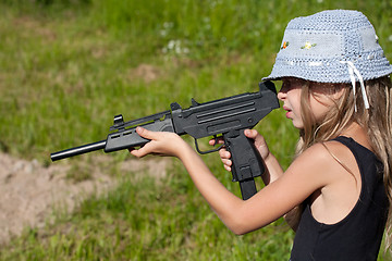 Image showing little girl firing a big gun