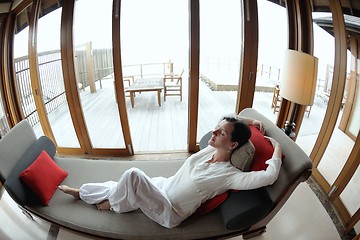 Image showing happy young woman relax at home on sofa