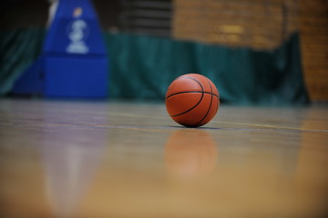 Image showing basketball ball and net on black background