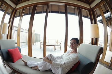 Image showing happy young woman relax at home on sofa