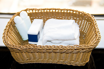 Image showing bath dispensers, soap and white towel on the tray