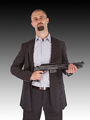 Image showing Mafia man is holding a shotgun