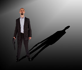 Image showing Mafia man is holding a shotgun