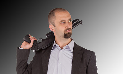 Image showing Mafia man is holding a shotgun