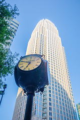 Image showing standing by the clock on city intersection at charlotte downtown