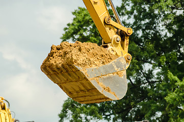 Image showing backhoe scoop of dirt