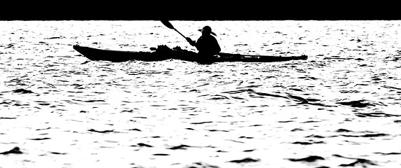 Image showing Sillouette of man kayaking on lake
