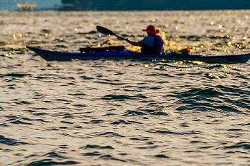 Image showing Sillouette of man kayaking on lake