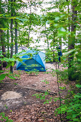 Image showing tent in forest on campground by the lake