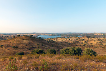 Image showing Rural landscape with grassland and a lake