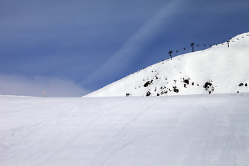 Image showing Ski slope and chair-lift against blue sky