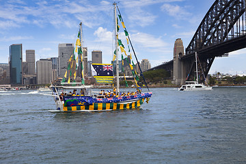 Image showing Decorated yacht sails under Sydney Harbour Bridge on Australia D