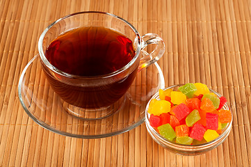 Image showing Cup of tea with candied fruits