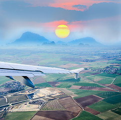 Image showing aerial view through airplane porthole 