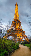 Image showing The Eiffel Tower Lit Up At Night From The Champ De Mars Park