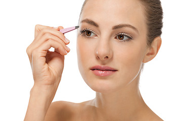 Image showing beautiful young woman and eyebrow tweezers 