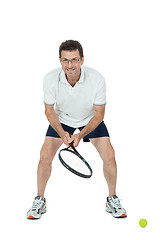 Image showing smiling adult tennis player with racket isolated