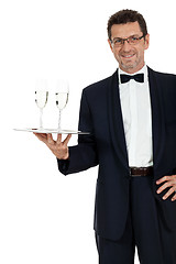 Image showing adult male waiter serving two glass of champagne isolated