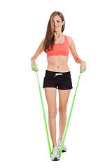 Image showing athletic young woman doing workout with physio tape latex tape