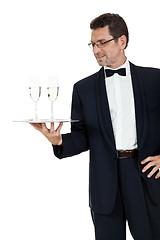 Image showing adult male waiter serving two glass of champagne isolated