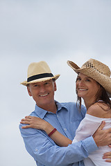 Image showing happy adult couple in summertime on beach 