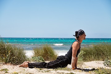 Image showing adult healthy man doing pilates yoga exercise 