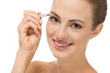 Image showing beautiful young woman and eyebrow tweezers 