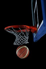 Image showing basketball ball and net on black background