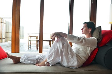 Image showing happy young woman relax at home on sofa