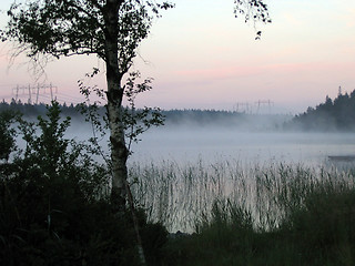 Image showing Misty lake at dawn, powerlines in the distance