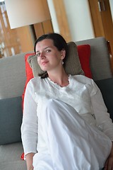 Image showing happy young woman relax at home on sofa