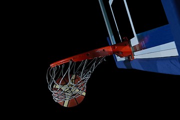 Image showing basketball ball and net on black background